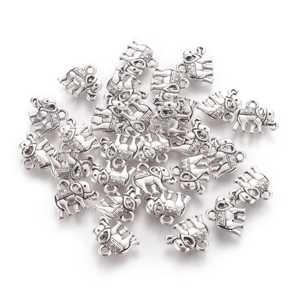 Description: Popular Tibetan Gold Elephant Charm Beads, Antique Silver Colored Vintage Elephant Charms for DIY Jewelry Making. Charms for Bracelet and Necklace Making.  Size: 12mm Length, 14mm Width, 2.5mm Thick, Hole: 1mm, Quantity: 10 pcs/package.  Material: Zinc Alloy (Lead and Nickel Free) Charms. Antique Silver Color. Shinny Finish.