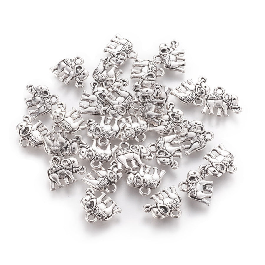 Description: Popular Tibetan Gold Elephant Charm Beads, Antique Silver Colored Vintage Elephant Charms for DIY Jewelry Making. Charms for Bracelet and Necklace Making.  Size: 12mm Length, 14mm Width, 2.5mm Thick, Hole: 1mm, Quantity: 10 pcs/package.  Material: Zinc Alloy (Lead and Nickel Free) Charms. Antique Silver Color. Shinny Finish.