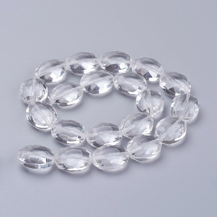Transparent Faceted Glass Crystal Beads, Oval Shape, Crystal Clear Color.   Size: 20mm Length, 16mm Width, 10mm Thick, , Hole: 1mm, approx. 20pcs/strand  Material: Glass; Austrian Crystal Imitation.  Shape: Oval, Faceted  Color: Clear  Usage: Focal Beads for DIY Jewelry Making.