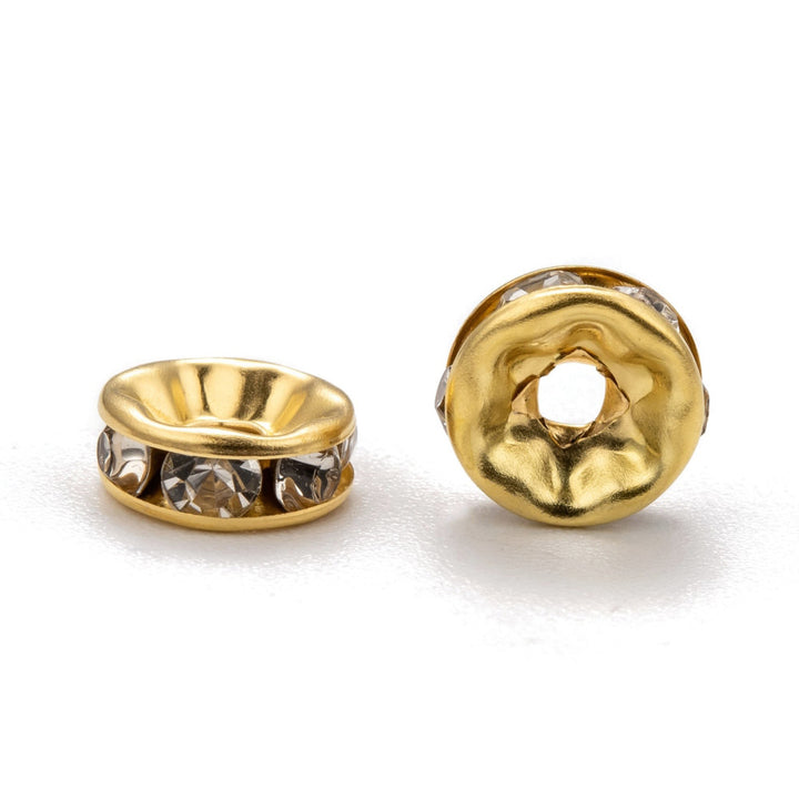Crystal Rondelle Rhinestone Spacer Beads, Round, Gold Color, Shinny Gold Spacer Charm Beads for DIY Jewelry Making. Add Some Shine and Sparkle to Your Creations. Size: 8mm Diameter, 2.5mm Thick, Hole Size: 2mm, approx. 50pcs/bag. Material: Gold Plated Crystal Rondelle Spacer Beads. Each Spacer Bead Features 6 Sparkling Mini Crystals. Shinny Finish.