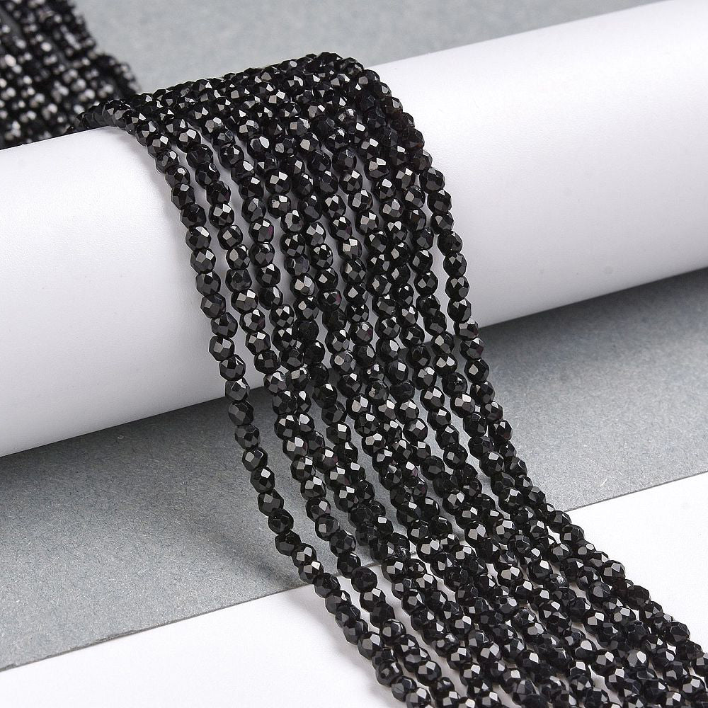 Faceted Glass Crystal Beads, Round, Black Color Beads.

Size:&amp;nbsp;2mm in Diameter, Hole: 0.8mm; approx. 150-165pcs/strand, 13" inches long.

Material: Transparent Faceted, Round, Black Color Glass Crystal Beads.