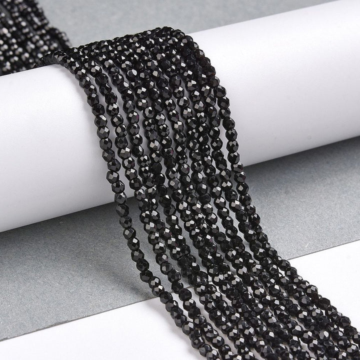 Faceted Glass Crystal Beads, Round, Black Color Beads.

Size:&amp;nbsp;2mm in Diameter, Hole: 0.8mm; approx. 150-165pcs/strand, 13" inches long.

Material: Transparent Faceted, Round, Black Color Glass Crystal Beads.