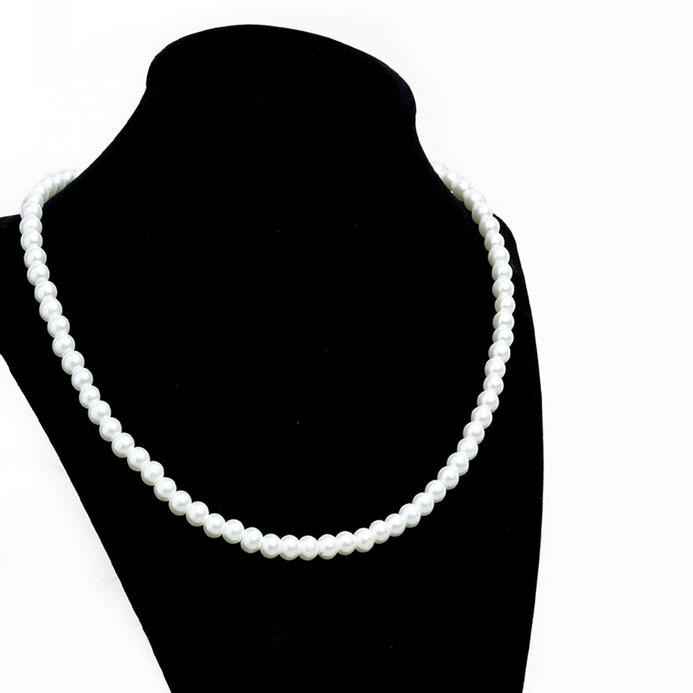 This timeless White Pearl Beaded Necklace is made with 6mm glass pearl beads, antique gold jewelry findings, chain extender and clasp. Hand strung on strong nylon thread cord, this 16" long necklace combines sophistication and style. Great for special occasions and weddings or just everyday wear.    Size: 16" Length with 6mm Beads and 2" Chain Extender.  Material: Glass Pearl Beads.