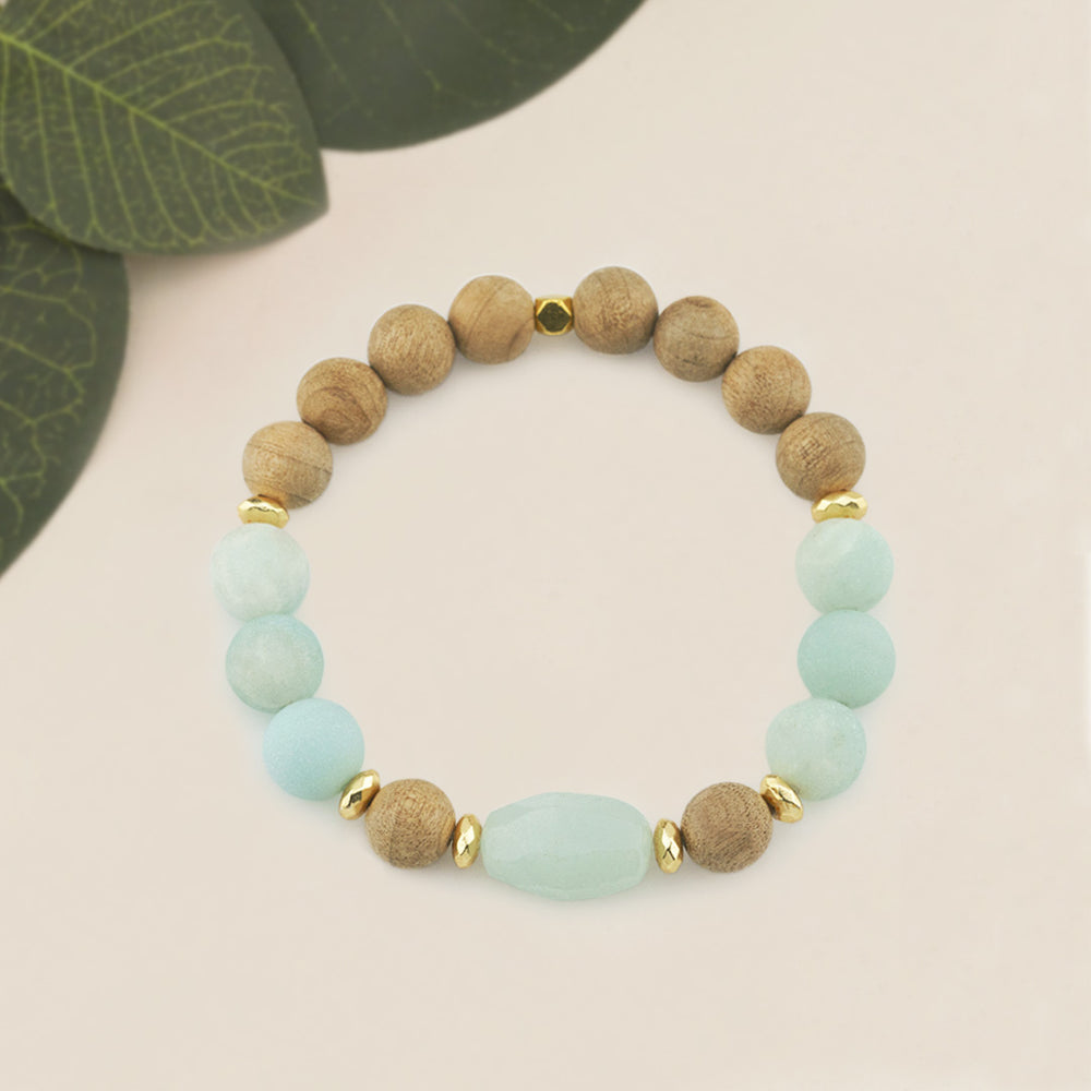 Amazonite &amp; Burlywood Wooden Beaded Gemstone Stretch Bracelet with Amazonite Centerpiece.

Elevate your style with this handcrafted Amazonite &amp; Burlywood Wooden Beaded Stretch Bracelet, featuring a striking faceted oval Amazonite centerpiece. Designed with a combination of 10mm Burlywood wooden beads, 10mm frosted Amazonite gemstone beads, and accented with 6mm gold faceted hematite rondelles and a 6mm gold square bead, this bracelet offers a harmonious blend of earthy tones and elegance.
