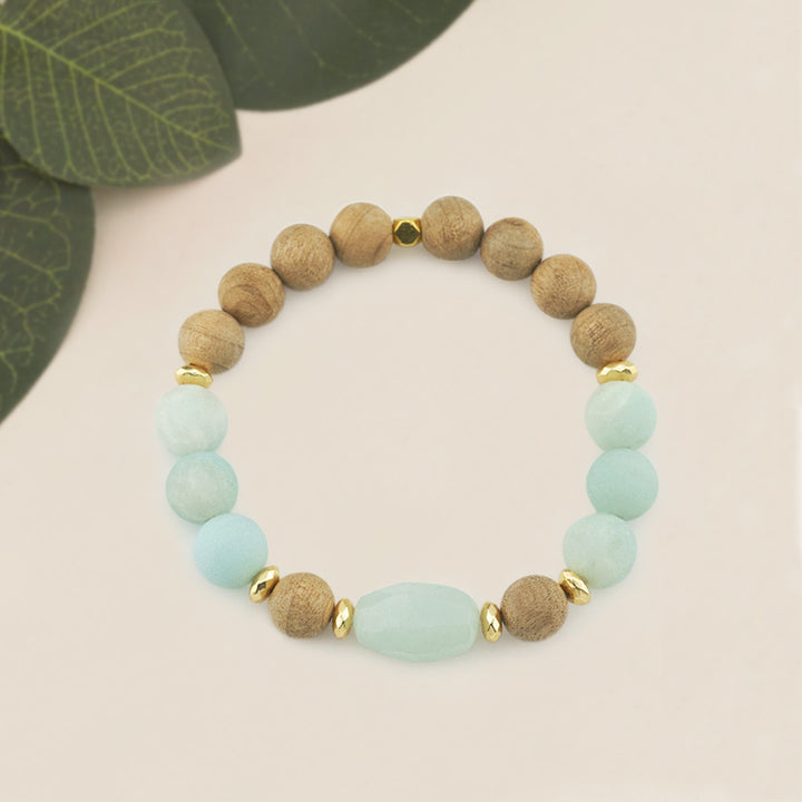 Amazonite &amp; Burlywood Wooden Beaded Gemstone Stretch Bracelet with Amazonite Centerpiece.

Elevate your style with this handcrafted Amazonite &amp; Burlywood Wooden Beaded Stretch Bracelet, featuring a striking faceted oval Amazonite centerpiece. Designed with a combination of 10mm Burlywood wooden beads, 10mm frosted Amazonite gemstone beads, and accented with 6mm gold faceted hematite rondelles and a 6mm gold square bead, this bracelet offers a harmonious blend of earthy tones and elegance.
