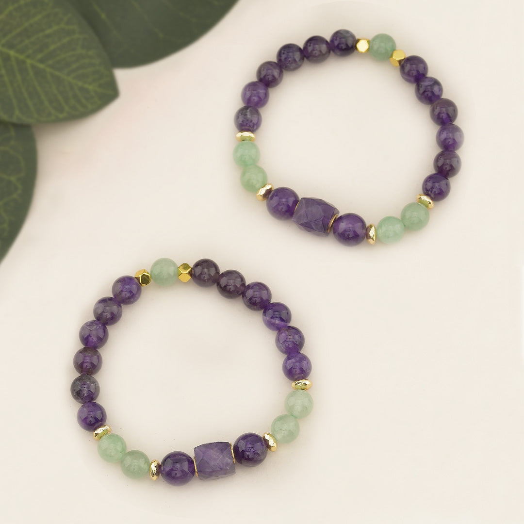 Amethyst &amp; Green Aventurine Beaded Gemstone Stretch Bracelet with Amethyst Centerpiece

This handcrafted Amethyst &amp; Green Aventurine Beaded Stretch Bracelet is a standout accessory featuring a beautiful 10x10mm faceted square amethyst bead as the focal point. Flanked by two 10mm amethyst beads, the centerpiece creates a balanced and eye-catching design. The bracelet also incorporates 8mm amethyst and green aventurine beads, along with 6mm gold faceted hematite accents, adding a touch of elegance.