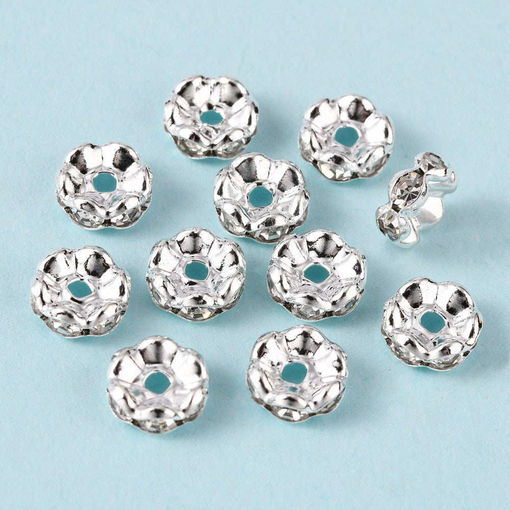 Silver Plated Brass Crystal Rondelle Rhinestone Spacer Beads, Wavy Edge, Shinny Silver Spacer Beads for DIY Jewelry Making. Add Some Shine and Sparkle to Your Creations.  Size: 8mm in Diameter, 3.5mm Thick, Hole Size: approx. 1.5mm, approx. 50pcs/bag.  Material: Brass Silver Plated Rondelle Spacer Beads. Wavy Edge. Each Spacer Bead Features 6 Clear Sparkling Mini Crystals. 
