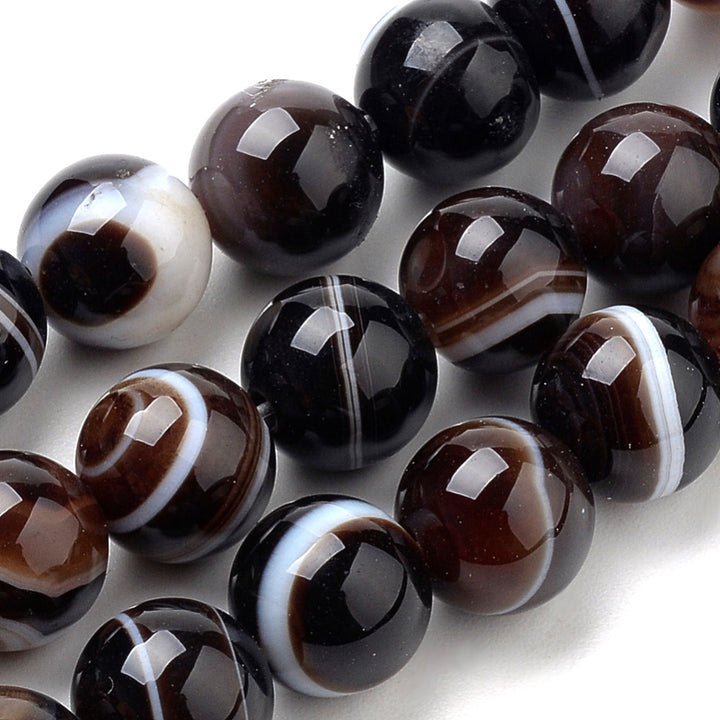 Coconut Brown Striped Banded Agate Beads, Round, dyed Coconut Brown Agate. Semi-Precious Gemstone Beads for Jewelry Making.   Available Sizes:  4mm Diameter, Hole: 1mm; approx. 85-90pcs/ strand, 14.5" Inches Long.  6mm Diameter, Hole: 1mm; approx. 60-63pcs/ strand, 14.5 Inches Long.  8mm Diameter, Hole: 1mm; approx. 44-47pcs/ strand, 14.5 Inches Long.  10mm Diameter, Hole: 1mm; approx. 35-37pcs/ strand, 14.5 Inches Long.  Material: Striped Banded Agate Loose Beads Dyed Brown Color. Polished, Shinny Finish.