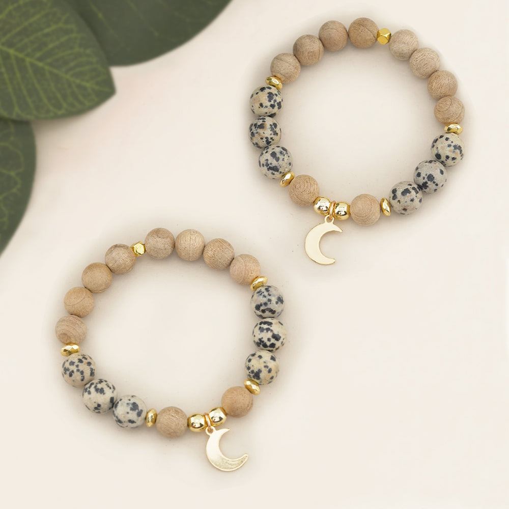 Chunky Beaded Gemstone Stretch Bracelet with Dalmatian Jasper, Burlywood Wooden Beads &amp; Gold Moon Charm.

Add a bold statement to your jewelry collection with this Chunky Beaded Gemstone Stretch Bracelet, featuring a unique blend of 10mm Dalmatian Jasper beads and Burlywood wooden beads. Designed for both style and comfort, this bracelet is strung on a durable stretchy elastic cord to ensure a perfect fit at 7.5 inches.