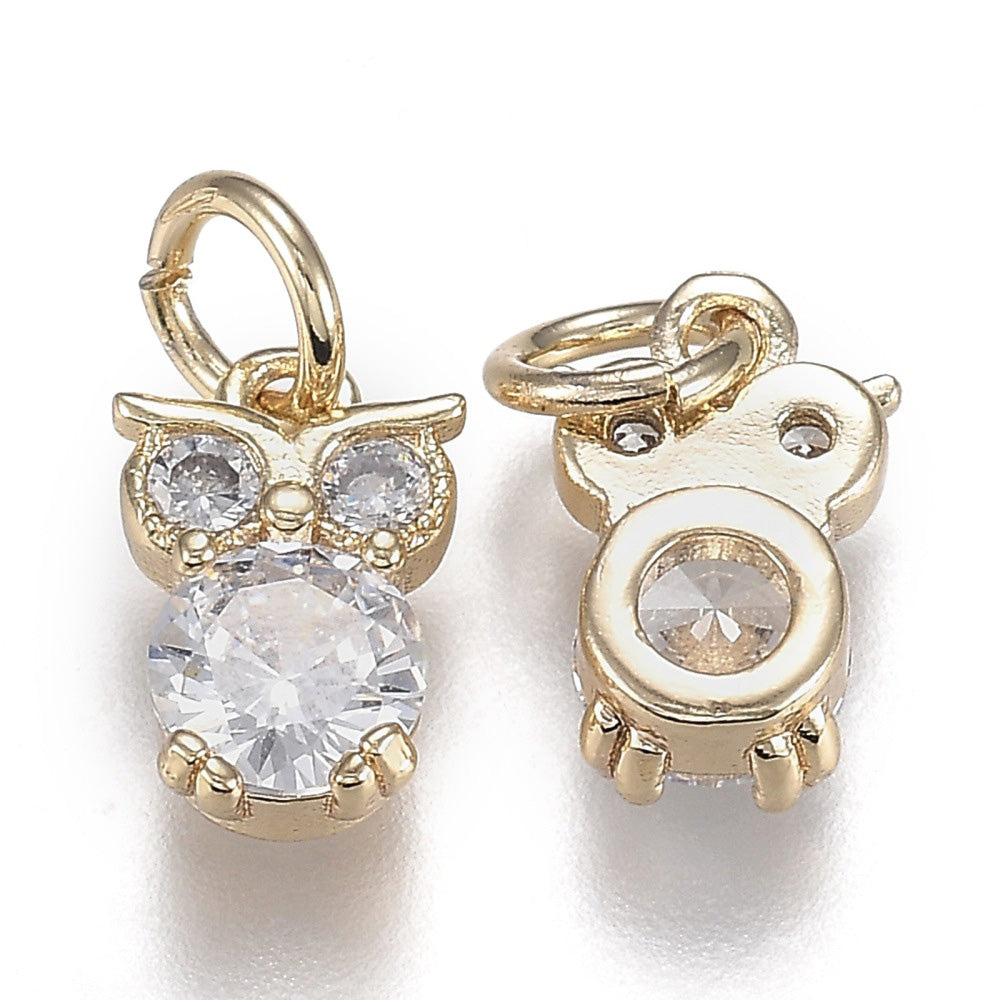 Elevate your jewelry designs with these stunning Cubic Zirconia Owl Charms. Crafted from brass and finished with 18k gold plating, each pendant features brilliant micro pave cubic zirconia stones that catch the light beautifully. The charming owl shape adds character and whimsy to bracelets, necklaces, and earrings.

At 12x8x3.5mm, these petite pendants are perfectly sized for delicate jewelry projects. Pre-attached jump rings make assembly effortless. Durable and long-lasting, these high-quality charms are