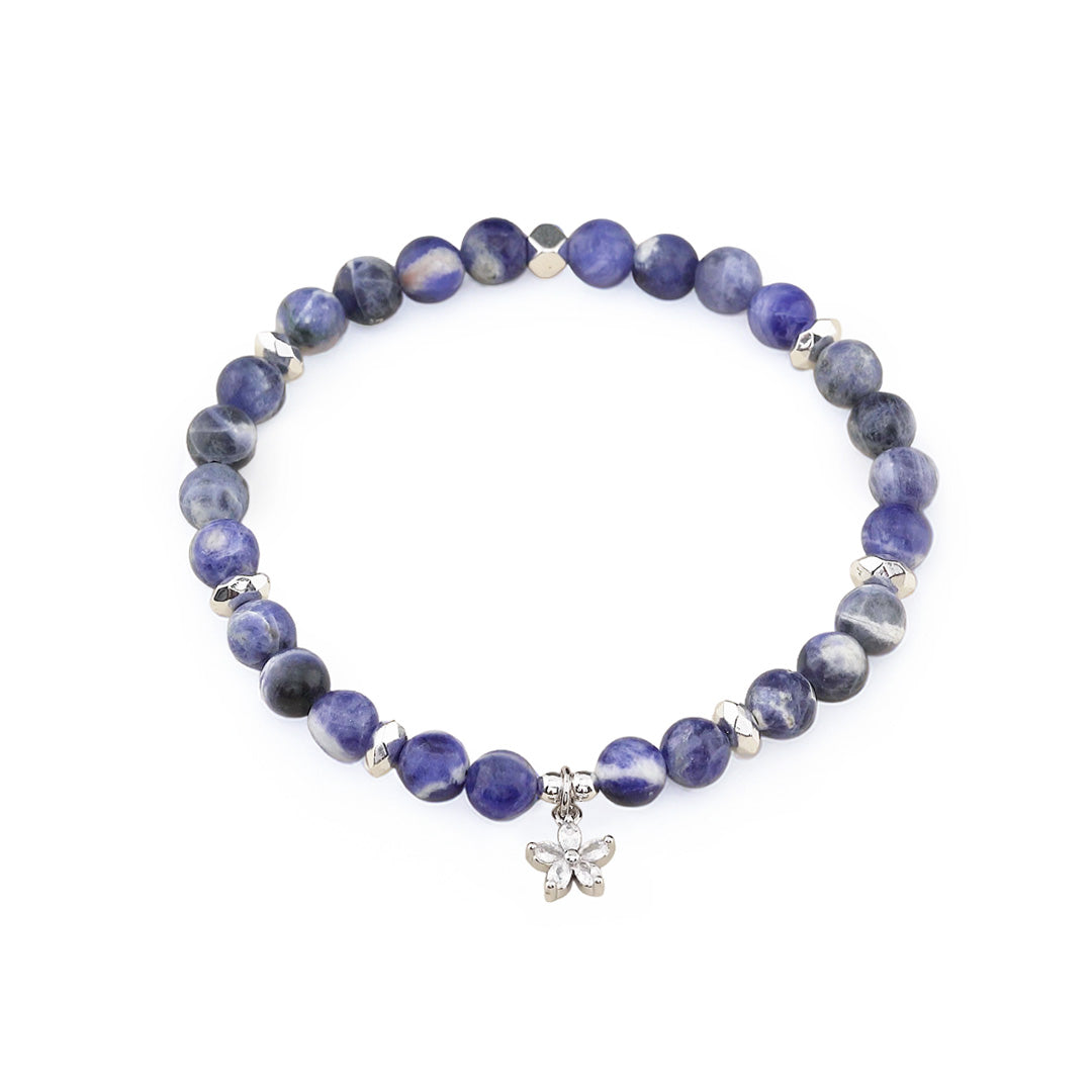 The Sodalite bracelet combines the deep, calming beauty of Sodalite beads with a silver cubic zirconia flower charm. Handcrafted to enhance intuition, promote emotional balance, and shield you from negativity, this piece is both a meaningful accessory and a stylish statement.