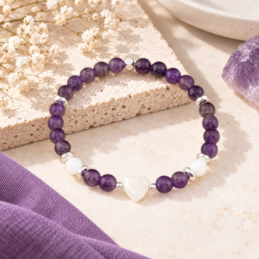 Crafted with 6mm amethyst and white jade gemstone beads, 6mm silver hematite rondelles, and 3mm silver hematite accents, this versatile piece pairs beautifully with everyday outfits and makes a thoughtful gift.