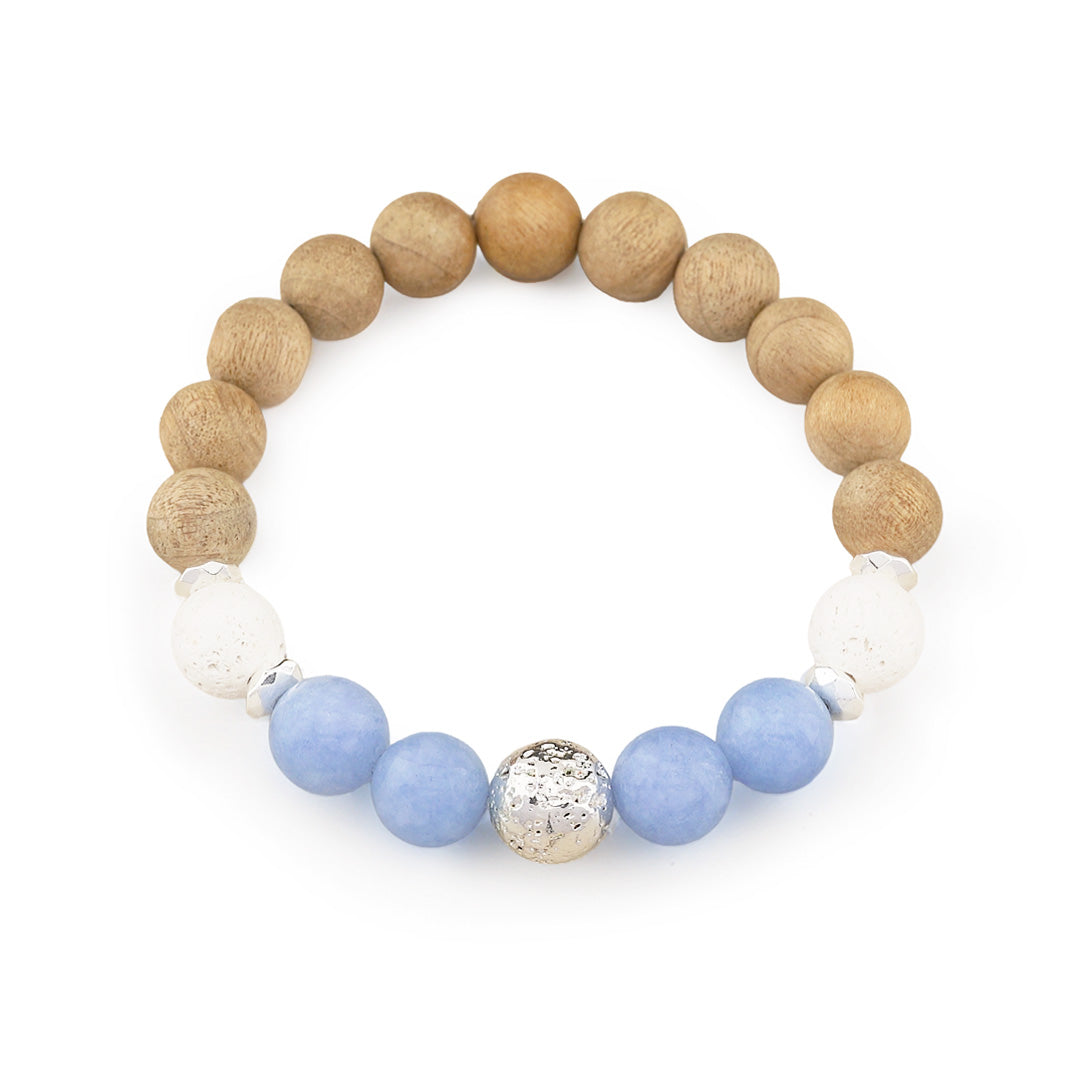 A beaded stretch bracelet featuring natural wood beads, white textured beads, light blue beads, and a central hammered silver accent bead, displayed on a clean white background.