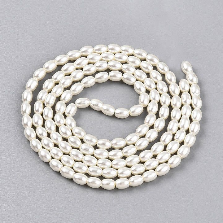 Rice Pearls, Glass Pearl Beads, Oval, Creamy White Color Pearls Beads for Jewelry Making.

Size: 6mm Length, 4-4.5mm With, Hole: 0.9mm, approx. 132pcs/strand, 30 inch/strand.

Material: The Beads are Made from Glass. Creamy White Color, Pearlized, Shinny Finish.