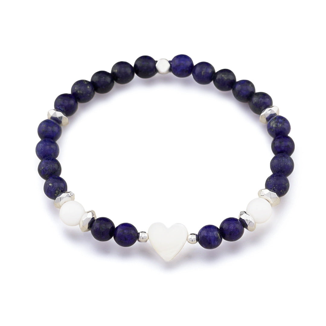 A beaded stretch bracelet featuring dark blue lapis lazuli stones, white agate beads, and a central white heart charm, accented with small silver spacer beads, shown on a white background.