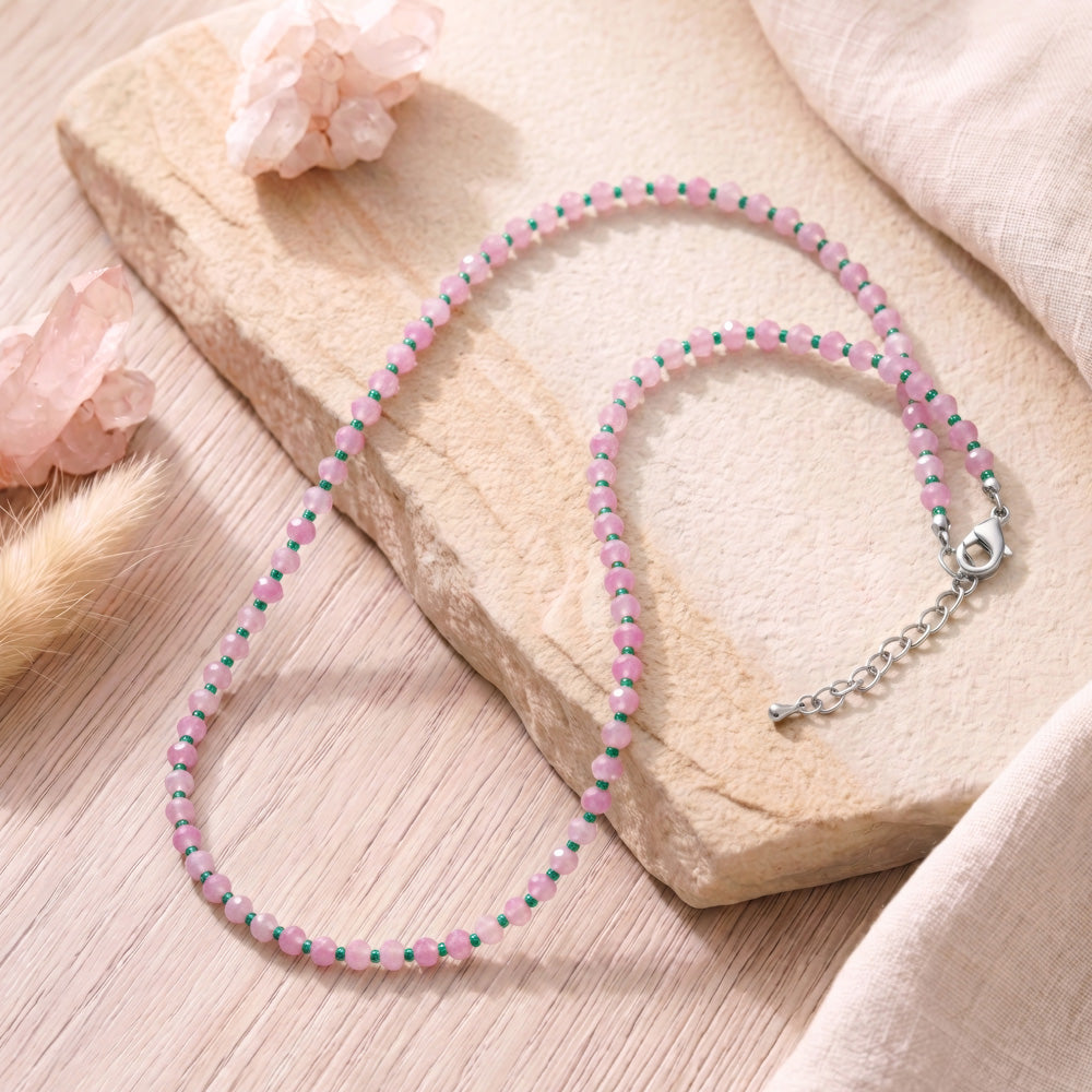 Stylish beaded gemstone necklace featuring 4x3mm pink and white jade rondelle beads paired with size 11/0 Czech seed beads in turquoise green. Perfect for everyday wear or evening occasions, and makes a thoughtful gift for friends and family. Includes a 2" chain extender and silver lobster clasp for secure fastening and adjustable fit.