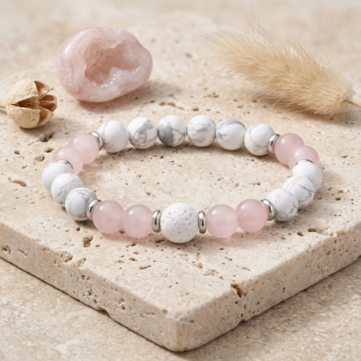 This charming bracelet is adorned with beaded gemstones, including 8mm Matte White Howlite, 8mm Rose Quartz, and 10mm White Lava Rock beads, complemented by silver-toned spacers. These mala bracelets are versatile, perfect for wearing alone or layering for a bohemian look. Ideal for any occasion or casual daily wear, they pair well with numerous styles.