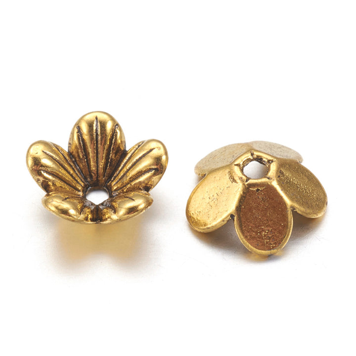 5 Petal Alloy Flower Spacer Beads. Flower Shaped Bead Caps, Gold Color. Flower Spacers for DIY Jewelry Making Projects.   Size: 9mm Diameter, 3mm Thick, Hole: 1.5mm, approx. 20pcs/package.  Material: Alloy 5 Petal Flower Bead Caps. Antique Gold Color. Lead, Cadmium &amp; Nickel Free.