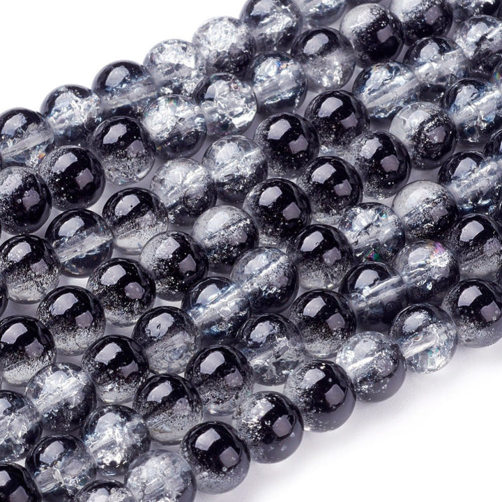 Popular Crackle Glass Beads, Round, Black and Clear Color. Glass Bead Strands for DIY Jewelry Making. Affordable, Colorful Crackle Beads. Great for Stretch Bracelets.  Size: 6mm Diameter Hole: 1.3mm; approx. 128pcs/strand, 31" Inches Long  Material: The Beads are Made from Glass. Crackle Glass Beads, Black Colored Beads with Clear Markings.  Polished, Shinny Finish.