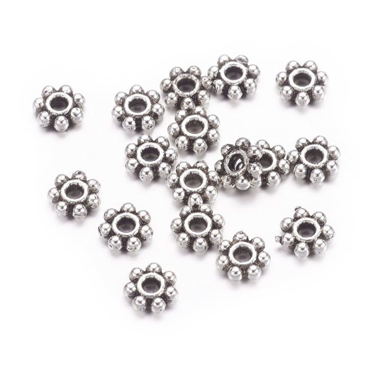 Alloy Daisy Spacer Beads, Flower, Antique Silver Color. Flower Shaped Alloy Spacers for DIY Jewelry Making Projects.  Size: 4-4.5mm Diameter, 1.5mm Thick, Hole: 1mm, approx. 100 pcs/package.  Material: Tibetan Alloy Daisy Spacers. Antique Silver Color Plated Flower Spacers. Lead and Nickel Free.