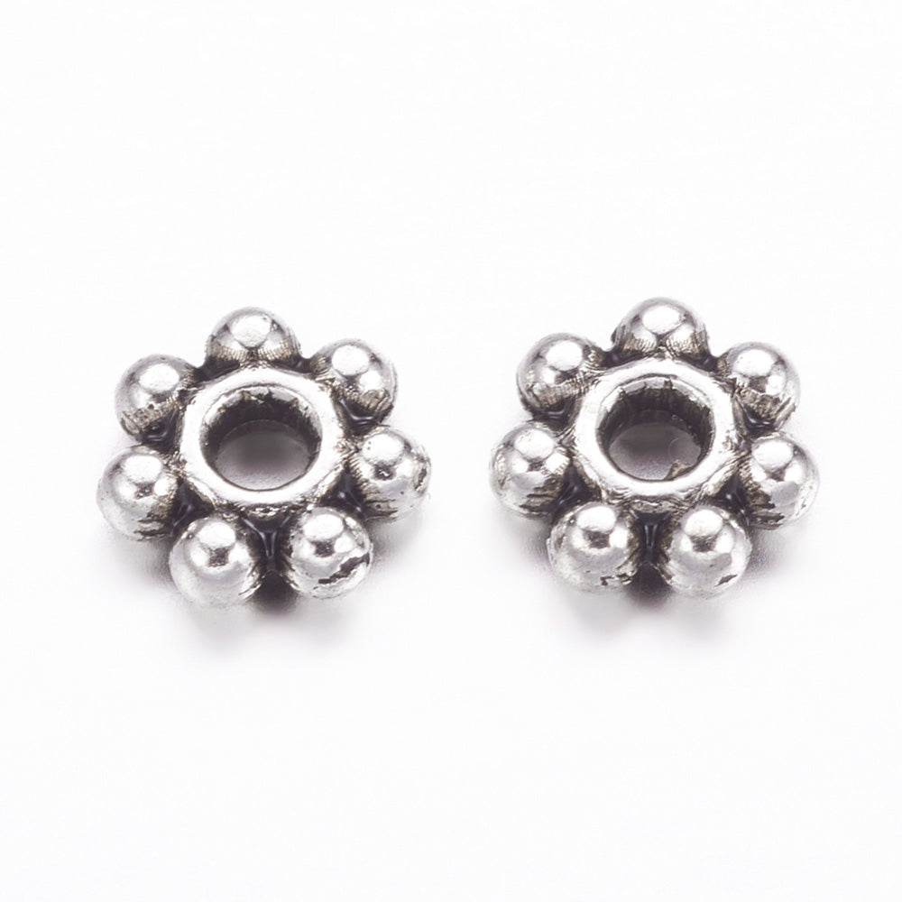 Alloy Daisy Spacer Beads, Flower, Antique Silver Color. Flower Shaped Alloy Spacers for DIY Jewelry Making Projects.  Size: 4-4.5mm Diameter, 1.5mm Thick, Hole: 1mm, approx. 100 pcs/package.  Material: Tibetan Alloy Daisy Spacers. Antique Silver Color Plated Flower Spacers. Lead and Nickel Free.