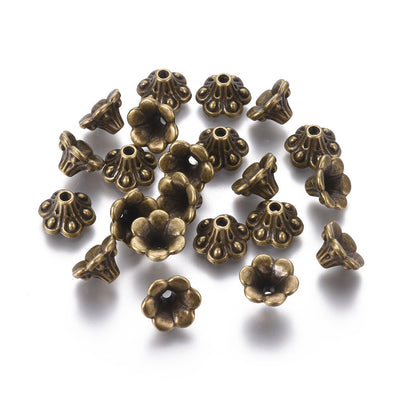 Antique Bronze Bell shaped Alloy Flower Spacer Beads. Flower Shaped Bead Caps, Bronze Color Bead Cones. Flower Spacers for DIY Jewelry Making Projects.   Size: 9mm Diameter, 5mm Length, Hole: 1.5mm, approx. 20pcs/package.  Material: Alloy Flower Bead Caps. Antique Bronze Color. Lead, Cadmium and Nickel Free.