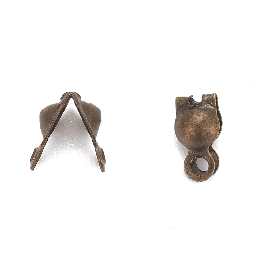Antique Bronze Color Iron Bead Tips, Bronze Color Clamshell Knot Covers for DIY Jewelry Making.  Size: 7mm Length, 4mm Diameter, approx. 25pcs/pkg  Material: Iron Bead Tip Clamshell Covers, Antique Bronze color Calotte Ends.  Usage: Clamshell Bead Tips are used to conceal knots where thread and metal jewelry findings meet. Used for finishing Jewelry Ends.