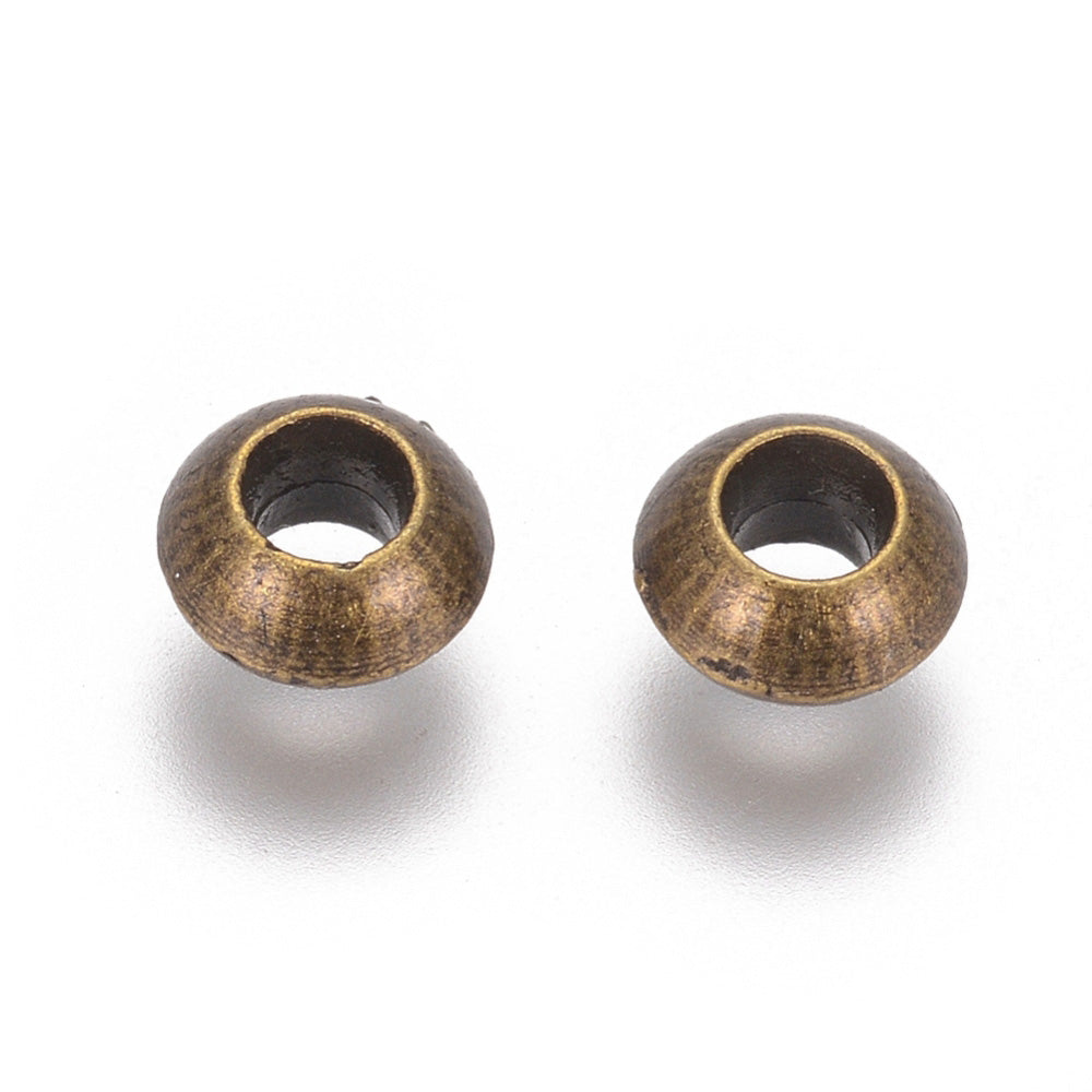 Antique Bronze Colored Spacer Beads, Rondelle shaped Spacers for DIY Jewelry Making.   Size: 5.5mm Diameter, Hole: 2.8mm, approx. 25pcs/bag.   Material: Antique Bronze Metal Alloy Spacer Beads. 100% Lead, Cadmium & Nickel Free Spacers.
