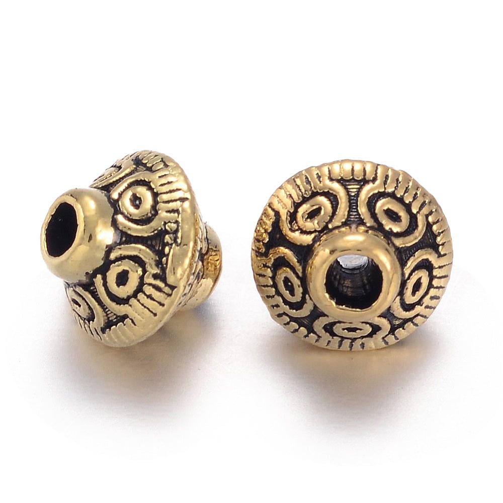 Tibetan Spacer Beads, Bicone, Antique Gold Color. Gold Spacers for DIY Jewelry Making Projects.   Size: 6.5mm Diameter, 7.5mm Width, Hole: 1mm, approx. 25pcs/bag.   Material: Antique Gold Alloy Spacers. 100% Lead, Cadmium and Nickel Free Spacers.