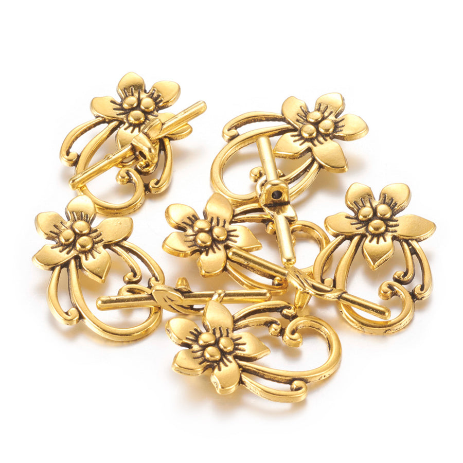 Antique Gold Flower Shaped Toggle Clasps for DIY Jewelry Making. Unique Toggle Clasp.  Size: 28mm Length, 20mm Width; Bar: 5x30mm, Hole: 2mm, 4 set/package.  Material: Antique Gold Color Alloy Toggle Clasps, Flower shape. Cadmium and Lead Free. 