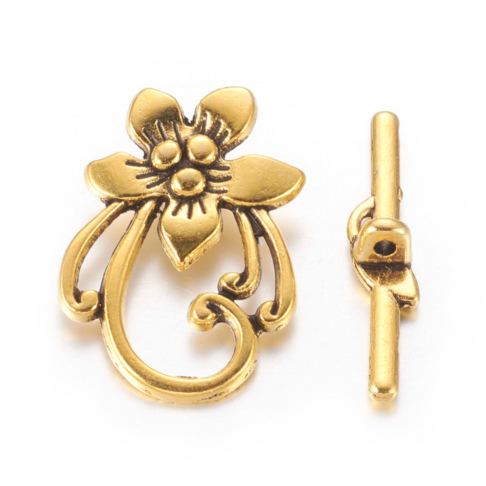 Antique Gold Flower Shaped Toggle Clasps for DIY Jewelry Making. Unique Toggle Clasp.  Size: 28mm Length, 20mm Width; Bar: 5x30mm, Hole: 2mm, 4 set/package.  Material: Antique Gold Color Alloy Toggle Clasps, Flower shape. Cadmium and Lead Free. 