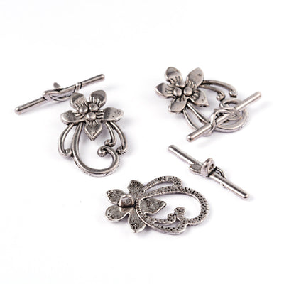 Antique Silver Flower Shaped Toggle Clasps for DIY Jewelry Making. Unique Toggle Clasp.  Size: 28mm Length, 20mm Width; Bar: 5x30mm, Hole: 2mm, 4 set/package.  Material: Silver Color Alloy Toggle Clasps, Flower shape. Cadmium, Nickel and Lead Free. 