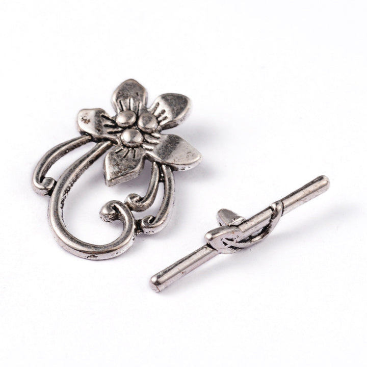 Antique Silver Flower Shaped Toggle Clasps for DIY Jewelry Making. Unique Toggle Clasp.  Size: 28mm Length, 20mm Width; Bar: 5x30mm, Hole: 2mm, 4 set/package.  Material: Silver Color Alloy Toggle Clasps, Flower shape. Cadmium, Nickel and Lead Free. 