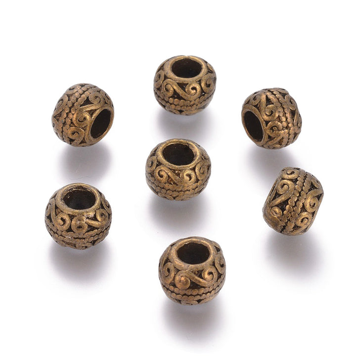 Large Hole European Metal Spacer Beads, Alloy Beads Antique Bronze Color, Round Rondelle Shape for DIY Jewelry Making.   Size: 10.5mm Diameter, 7.5mm Thick, Hole: 5mm, Quantity: 5pcs/package.  Material: Alloy European Large Hole Beads. Antique Bronze Color with a Pattern.