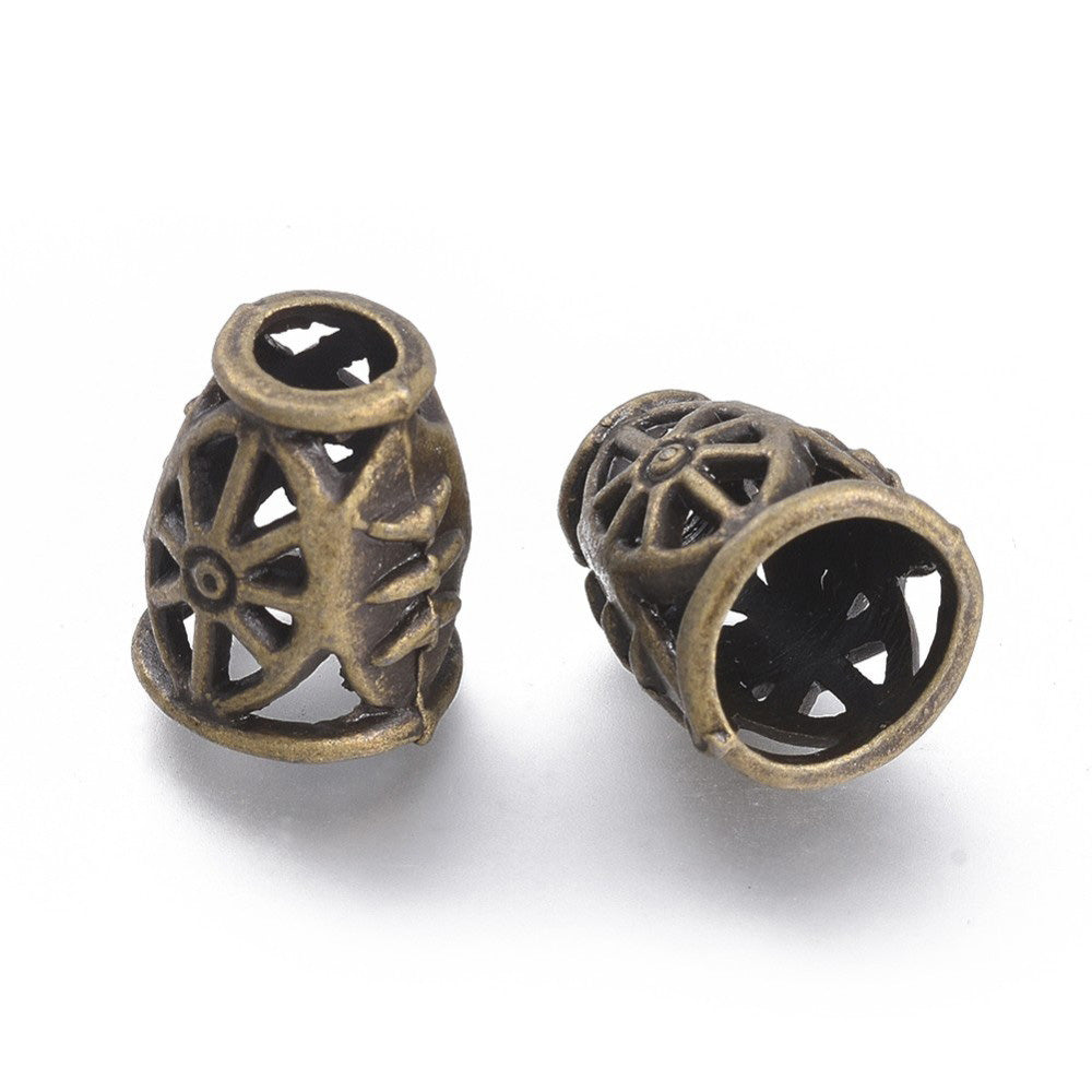 Antique Bronze Alloy Bead Cones. Cart Wheel Design Bead Caps, Bronze Color Bead Cones.   Size: 11.5mm Diameter, 14mm Length, 9mm inner diameter, Qty: 4pcs/package.  Material: Alloy Bead Cones. Antique Bronze Color. Lead, Cadmium and Nickel Free.