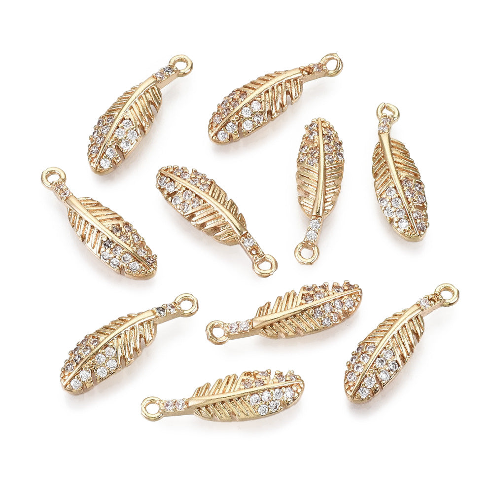 Brass Micro Pave Cubic Zirconia Feather Charms. Light Gold Plated Feather Shaped Pendant Charms for DIY Jewelry Making.   Size: 17mm Length, 5mm Width, 2.5mm Thick, Hole: 1mm, Quantity: 1pcs/package.  Material: Cubic Zirconia Brass Micro Pave Feather Charms. Real Light Gold Plated.