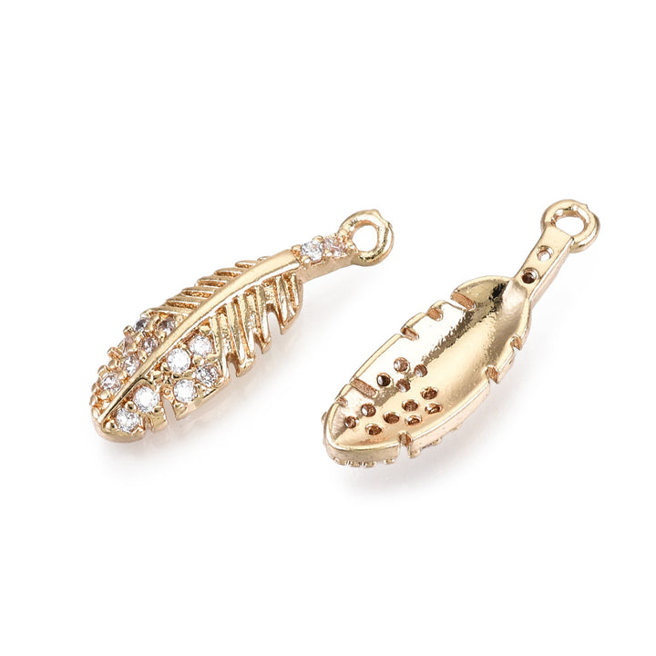 Brass Micro Pave Cubic Zirconia Feather Charms. Light Gold Plated Feather Shaped Pendant Charms for DIY Jewelry Making.   Size: 17mm Length, 5mm Width, 2.5mm Thick, Hole: 1mm, Quantity: 1pcs/package.  Material: Cubic Zirconia Brass Micro Pave Feather Charms. Real Light Gold Plated.