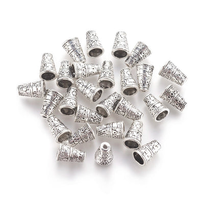 Alloy Bead Cones, Antique Silver Colored Cones for DIY Jewelry Making. Add the perfect Finishing Touch to Your Jewelry Designs with these Stylish Cones. Jewelry Finishing Ends.  Size: 7mm Diameter, 10mm Length, Hole: 2mm, Quantity: 5pcs/bag. bead lot. www.beadlot.com