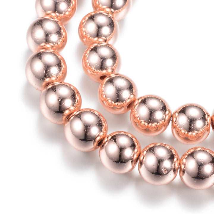 Stunning Rose Gold Hematite Spacer Beads, Electroplated Non-magnetic Synthetic Hematite Bead Strands, Round, Rose Gold Plated. Rose Gold Spacers for Jewelry Making. Size: 4mm in diameter, hole: 1~1.5mm; approx. 92~95pcs/strand, 15.7 inches. Material: Non-Magnetic Electroplated Rose Gold Hematite. Polished, Shinny Finish. Bead Lot. beadlot. beadlotcanada. www.beadlot.com