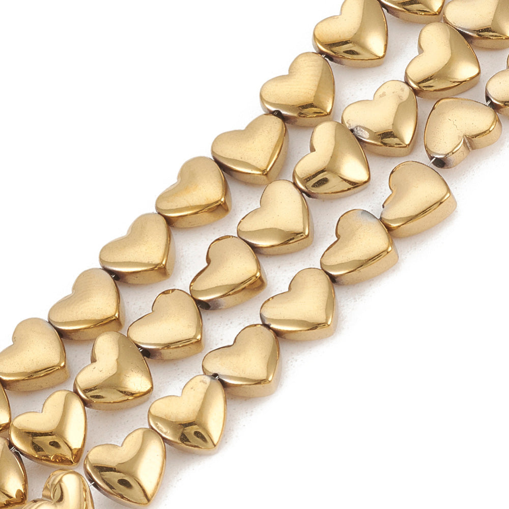 Non-Magnetic Hearth Shaped Synthetic Hematite Beads, Gold Color. Semi-Precious Stone Spacer Beads for Jewelry Making.   Size: 7mm Length, 5.5mm Width, Hole: 1mm, approx. 68-70pcs/strand, 15" Inches Long.  Material: Non-Magnetic Synthetic Hematite Beads. Gold Plated Flat Heart Shaped Spacer Beads. Polished, Shinny Metallic Lustrous Finish.