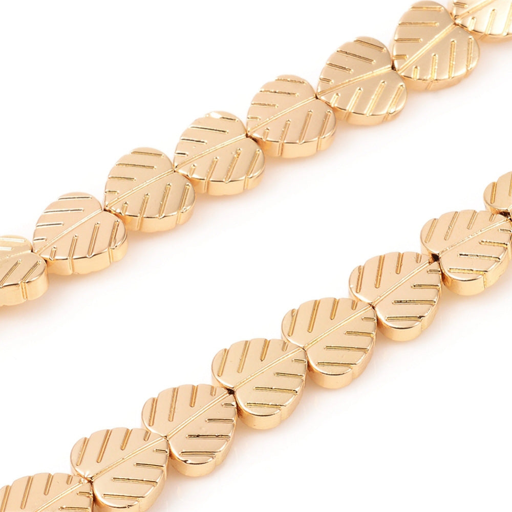 Electroplated Non-Magnetic Hematite Leaf Beads, Metallic Gold Color. Semi-Precious Stone Beads for Jewelry Making. Affordable High Quality Spacer Beads for Mala Bracelets.  Size: 8mm Length, 8mm Width, 2.5mm Thick, Hole: 1mm, approx. 52-55pcs/strand, 15.5" Inches Long.  Material: Leaf Shaped Non-Magnetic Synthetic Hematite Bead Strands. Metallic Light Gold Color. Polished, Shinny Metallic Lustrous Finish.