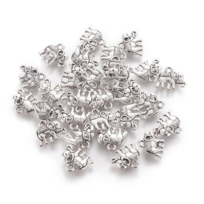 Description: Popular Tibetan Gold Elephant Charm Beads, Antique Silver Colored Vintage Elephant Charms for DIY Jewelry Making. Charms for Bracelet and Necklace Making.  Size: 12mm Length, 14mm Width, 2.5mm Thick, Hole: 1mm, Quantity: 10 pcs/package.  Material: Zinc Alloy (Lead and Nickel Free) Charms. Antique Silver Color. Shinny Finish.