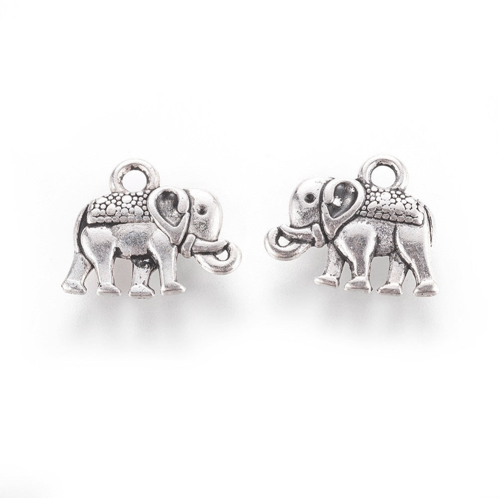 Description: Popular Tibetan Gold Elephant Charm Beads, Antique Silver Colored Vintage Elephant Charms for DIY Jewelry Making. Charms for Bracelet and Necklace Making.  Size: 12mm Length, 14mm Width, 2.5mm Thick, Hole: 1mm, Quantity: 10 pcs/package.  Material: Zinc Alloy (Lead and Nickel Free) Charms. Antique Silver Color. Shinny Finish.