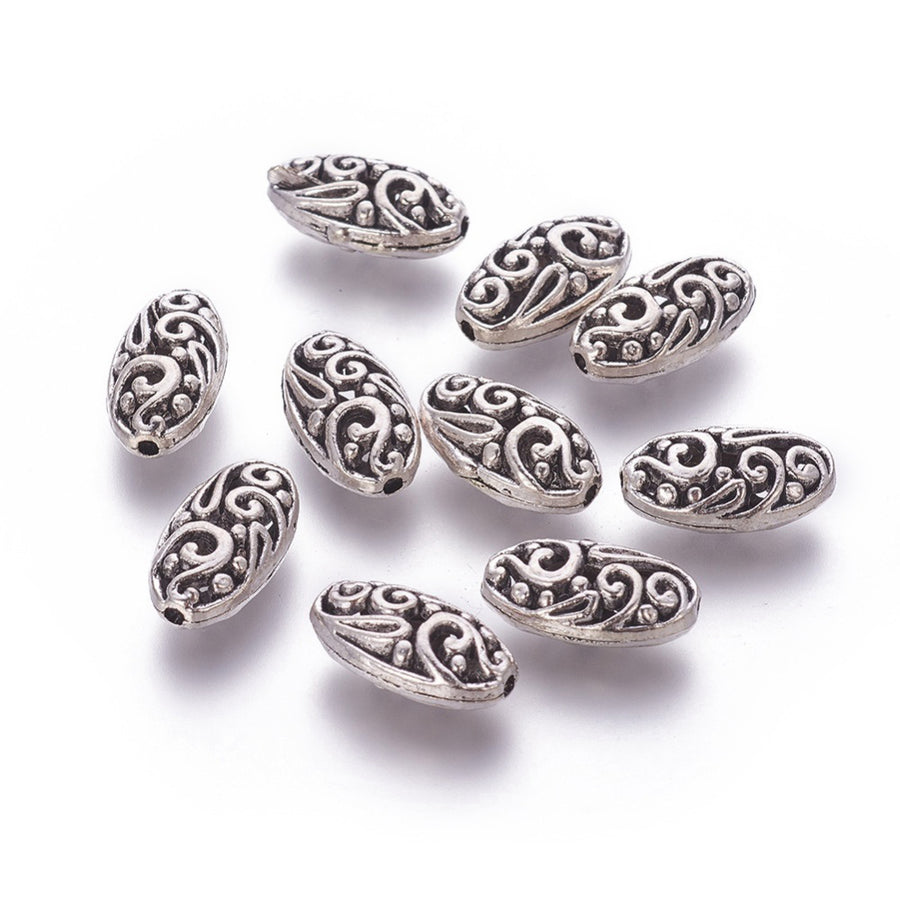 Oval Alloy Focal Bead, Metal Spacer Beads, Oval Filigree Beads with a Design, Antique Silver Color.  Size: 18mm Length, 10mm Width, 7mm Thick,  Hole: 1mm, Quantity: 1pcs  Material: Alloy (Lead, Cadmium and Nickel Free) Antique Silver Color, Oval with Pattern.