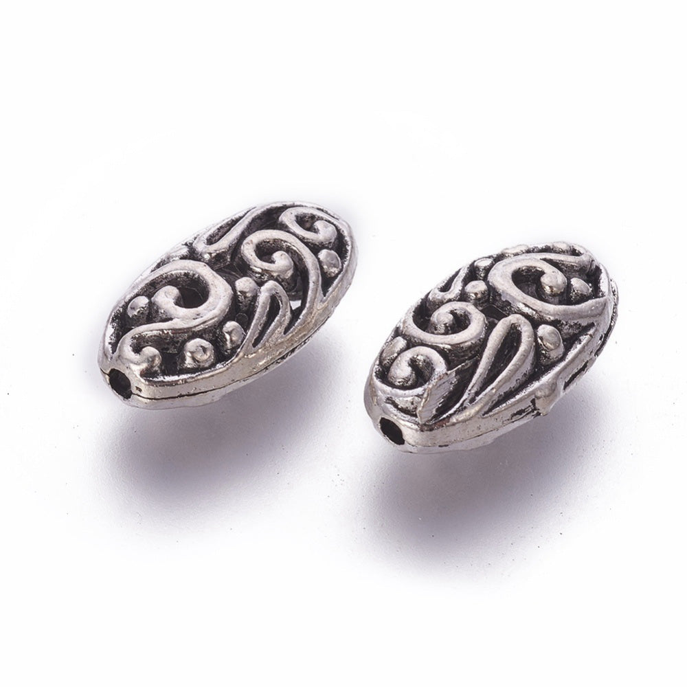 Oval Alloy Focal Bead, Metal Spacer Beads, Oval Filigree Beads with a Design, Antique Silver Color.  Size: 18mm Length, 10mm Width, 7mm Thick,  Hole: 1mm, Quantity: 1pcs  Material: Alloy (Lead, Cadmium and Nickel Free) Antique Silver Color, Oval with Pattern.