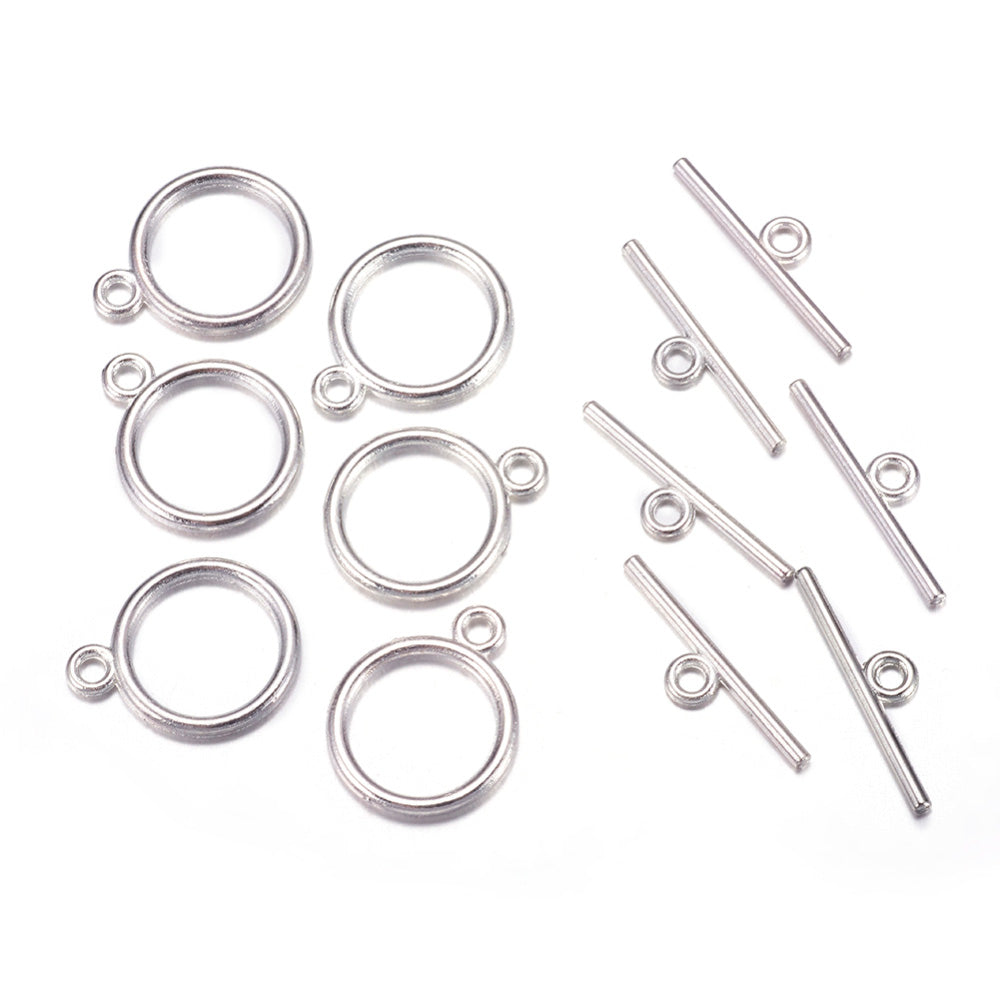 Toggle Ring Clasp for DIY Jewelry Making. Antique Silver Color, Flat, Round Clasps.  Size: Ring: 15mm, 2mm Thick, Bar: 21mm, Hole: 2mm, 5 set/package.  Material: Alloy Toggle Clasps, Cadmium, Nickel and Lead Free, Antique Silver Color Clasp.   Usage: These Clasp are used to finish of necklaces or bracelets.