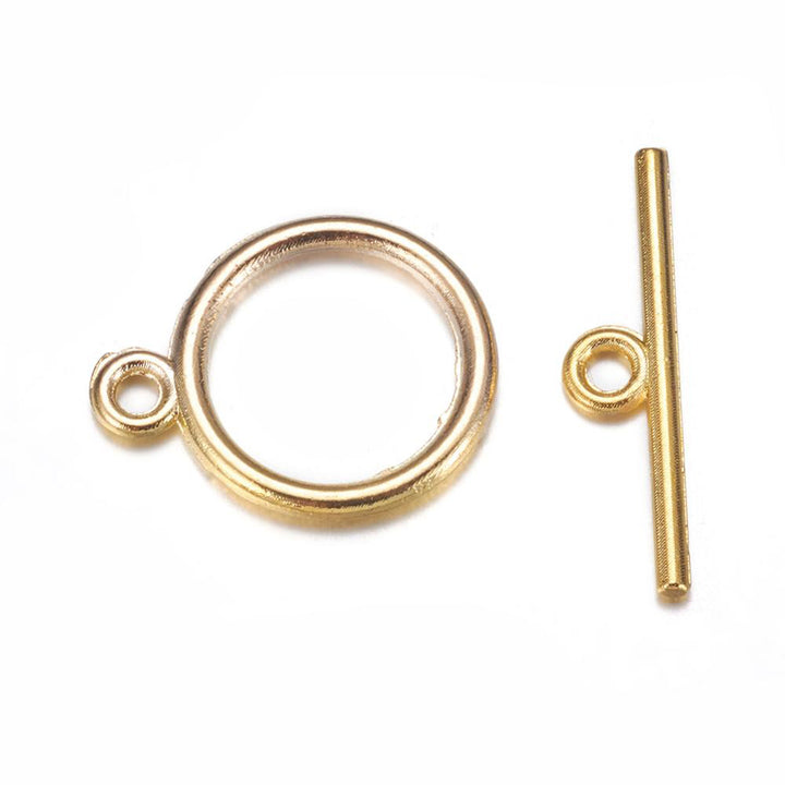 Toggle Ring Clasp for DIY Jewelry Making. Antique Gold Color, Flat, Round Clasps.  Size: Ring: 15mm, 2mm Thick, Bar: 21mm, Hole: 2mm, 5 set/package.  Material: Alloy Toggle Clasps, Cadmium, Nickel and Lead Free, Antique Gold Color Clasp. 