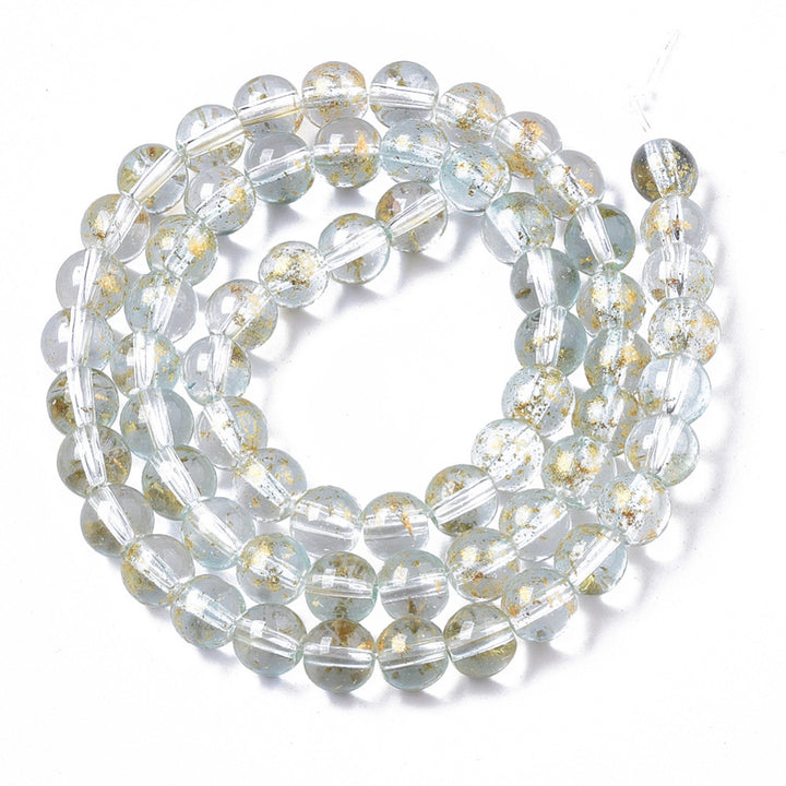 Gold Foiled Transparent Glass Beads, Round, Clear with Blue Hue. Quality Clear Blue Glass Beads for DIY Jewelry Making.   Size: 6mm Diameter, Hole: 1.2mm; approx. 62pcs/strand, 14.5" inches long.  Material: Transparent Glass Beads, Loose Clear Glass Beads with Gold Foil, and Blue Hue. Shinny Finish.