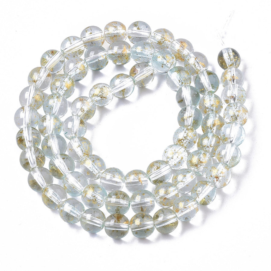 Gold Foiled Transparent Glass Beads, Round, Clear with Blue Hue. Quality Clear Blue Glass Beads for DIY Jewelry Making.   Size: 6mm Diameter, Hole: 1.2mm; approx. 62pcs/strand, 14.5" inches long.  Material: Transparent Glass Beads, Loose Clear Glass Beads with Gold Foil, and Blue Hue. Shinny Finish.