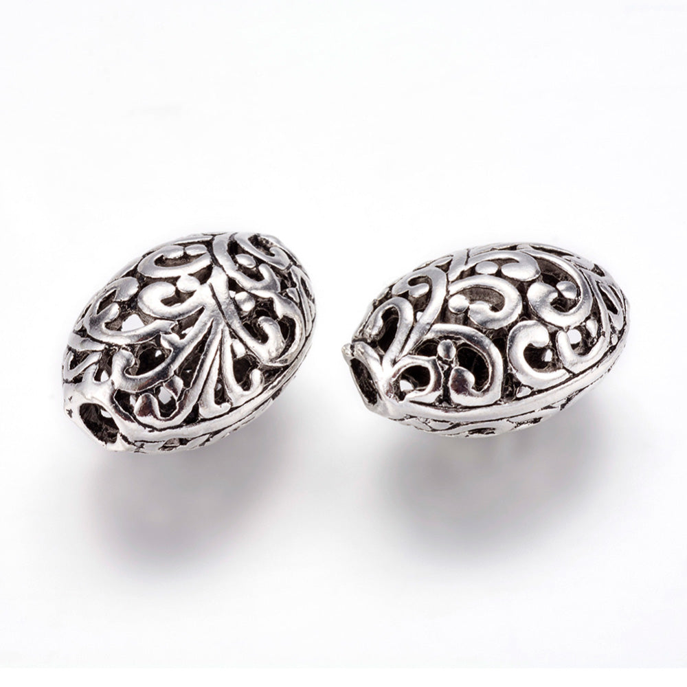 Large Hollow Oval Focal Bead with a Design, Antique Silver Color, Oval Shape for DIY Jewelry Making.   Size: 16.5mm Width, 22mm Length, 12.5mm Thick, Hole: 3mm, Qty: 1pcs/package.  Material: Alloy Large Hole Beads. Antique Silver Color with a Pattern.